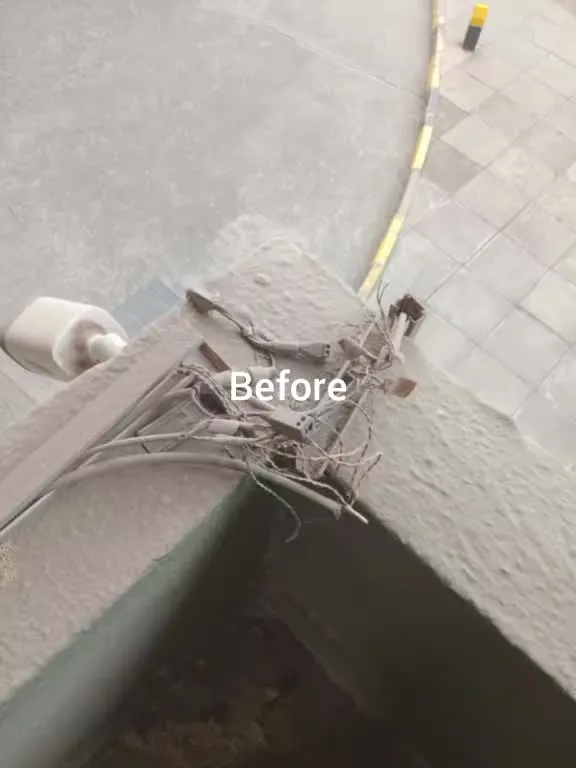 Before the upgrade: exposed, weathered CCTV cable joints and an old camera on a parapet