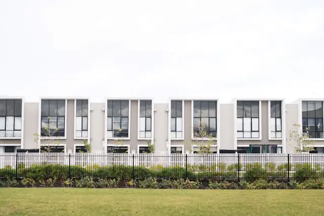 Row of townhouses behind a fence