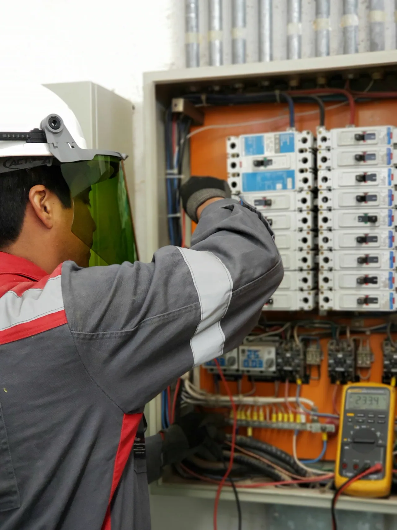 Electrician testing an electrical distribution panel