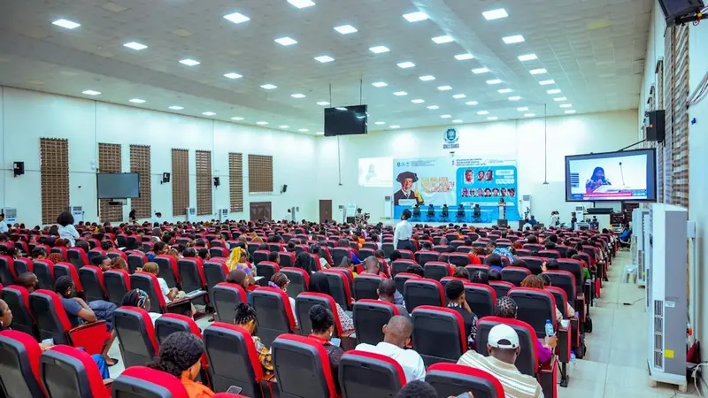 Audience seated in a large conference hall