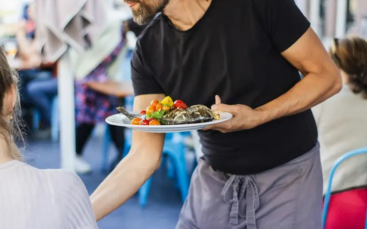 Waiter carrying a plate