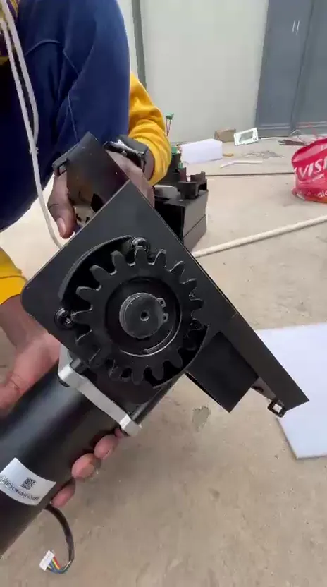 Technicians assembling an automatic gate motor on site
