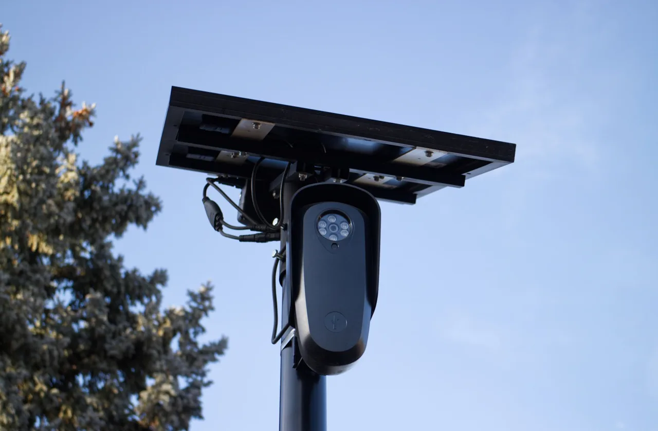 Solar panel and camera unit mounted on a pole