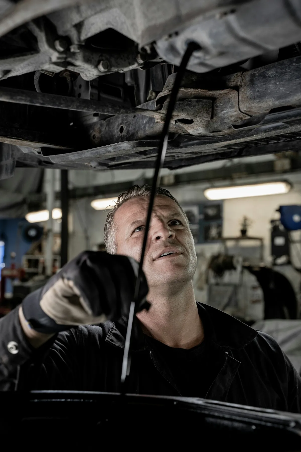 Technician working under a car