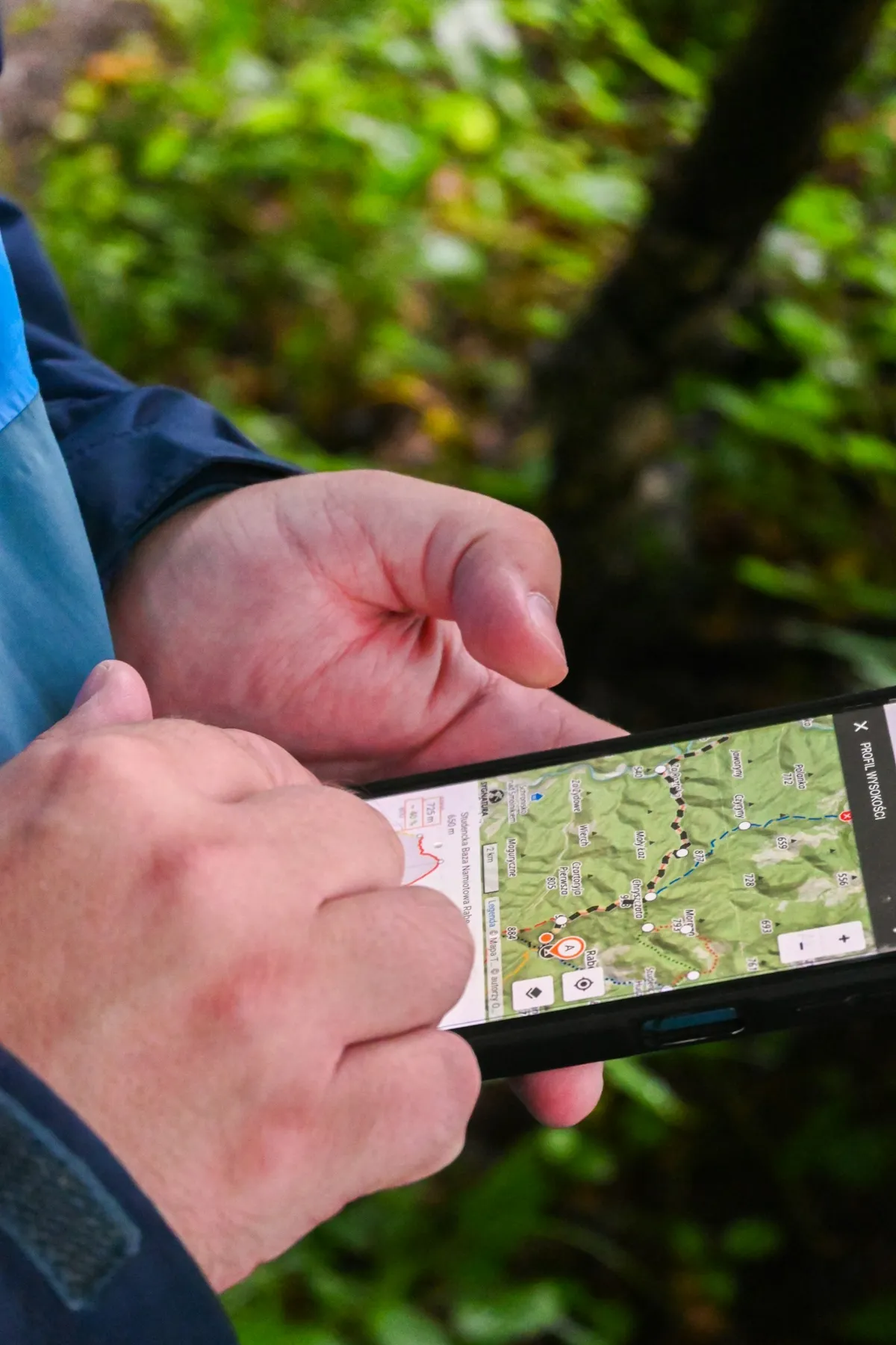 Hands holding a smartphone showing a map